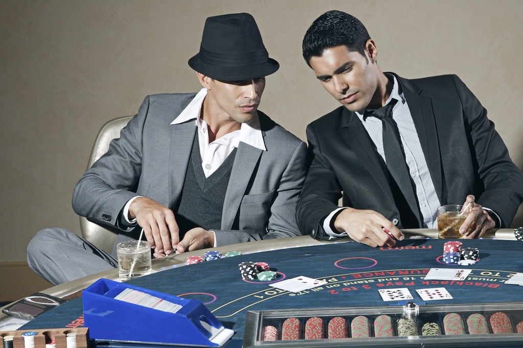 men-wearing-suits-playing-poker-at-table
