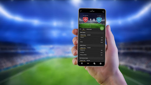 hand-holding-up-phone-with-betting-app