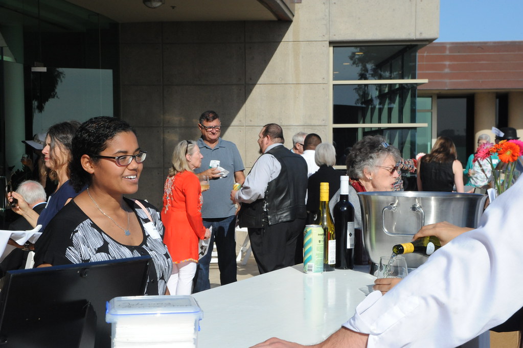 people-gathered-at-event-with-lady-running-table