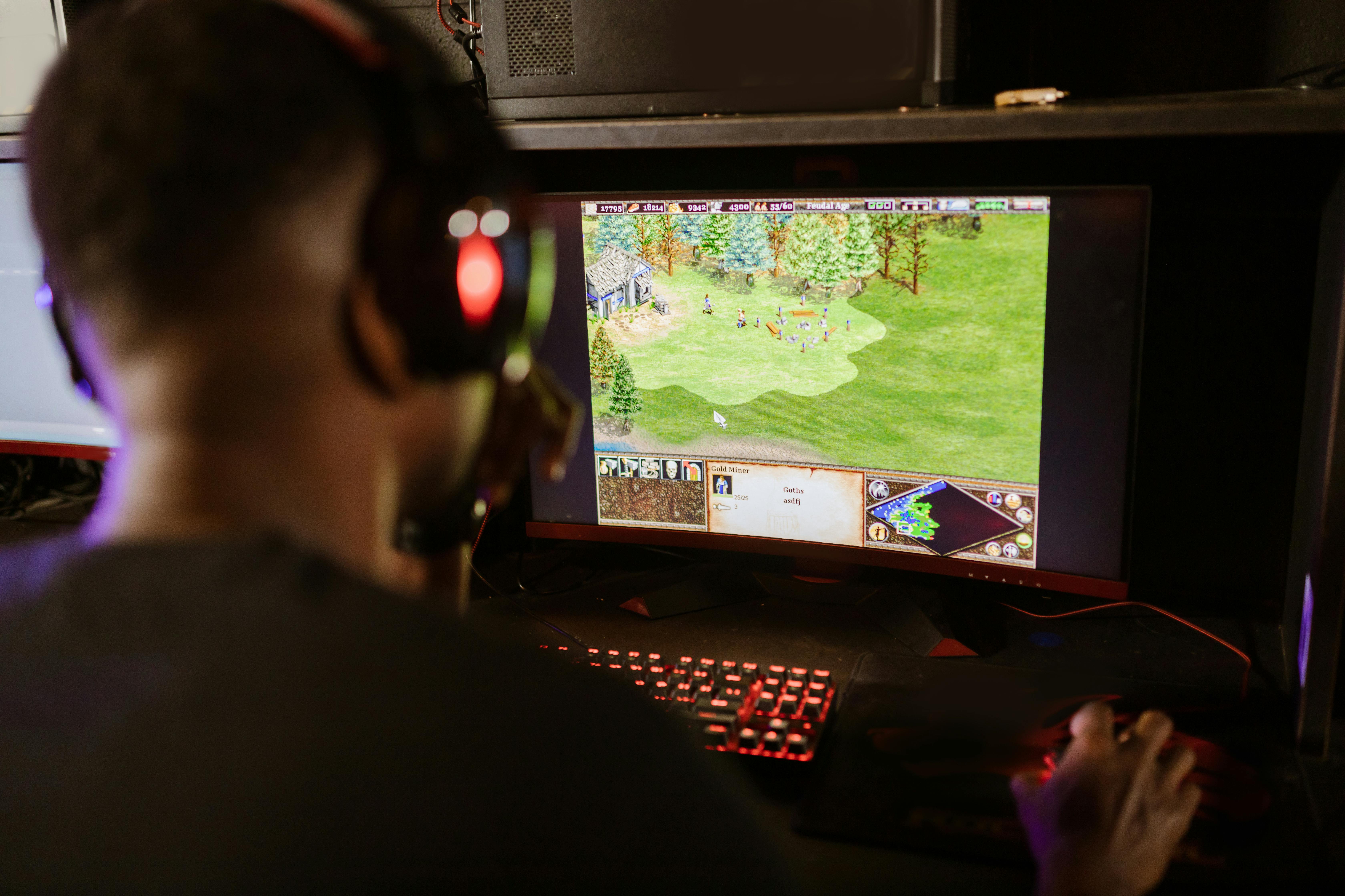 man-playing-world-building-video-game-on-computer