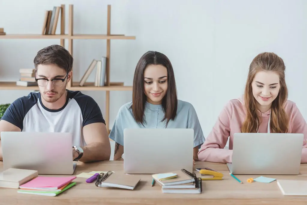 three-students-learning-courses-on-laptops