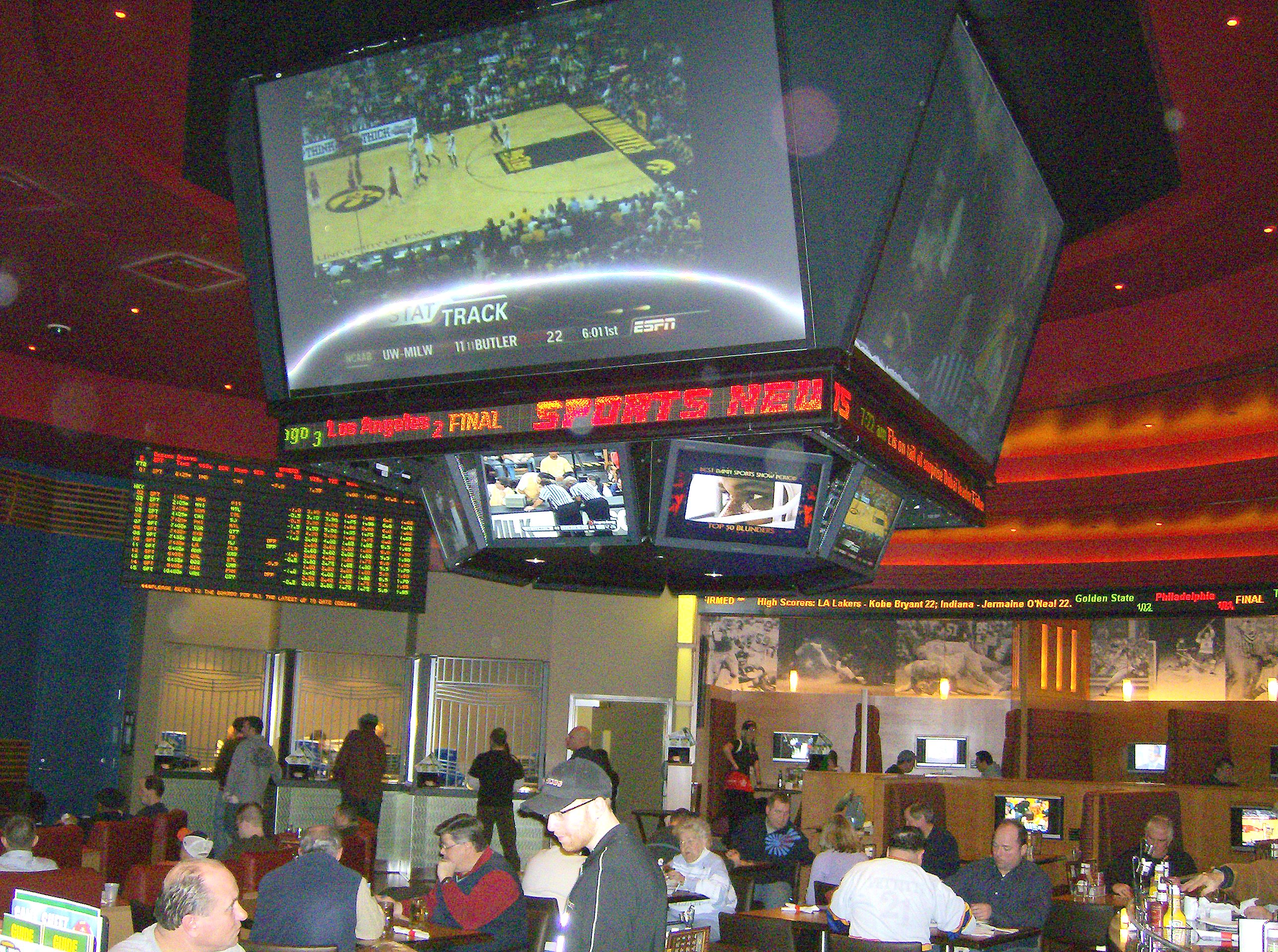 people-gathered-around-jumbotron-in-cafateria