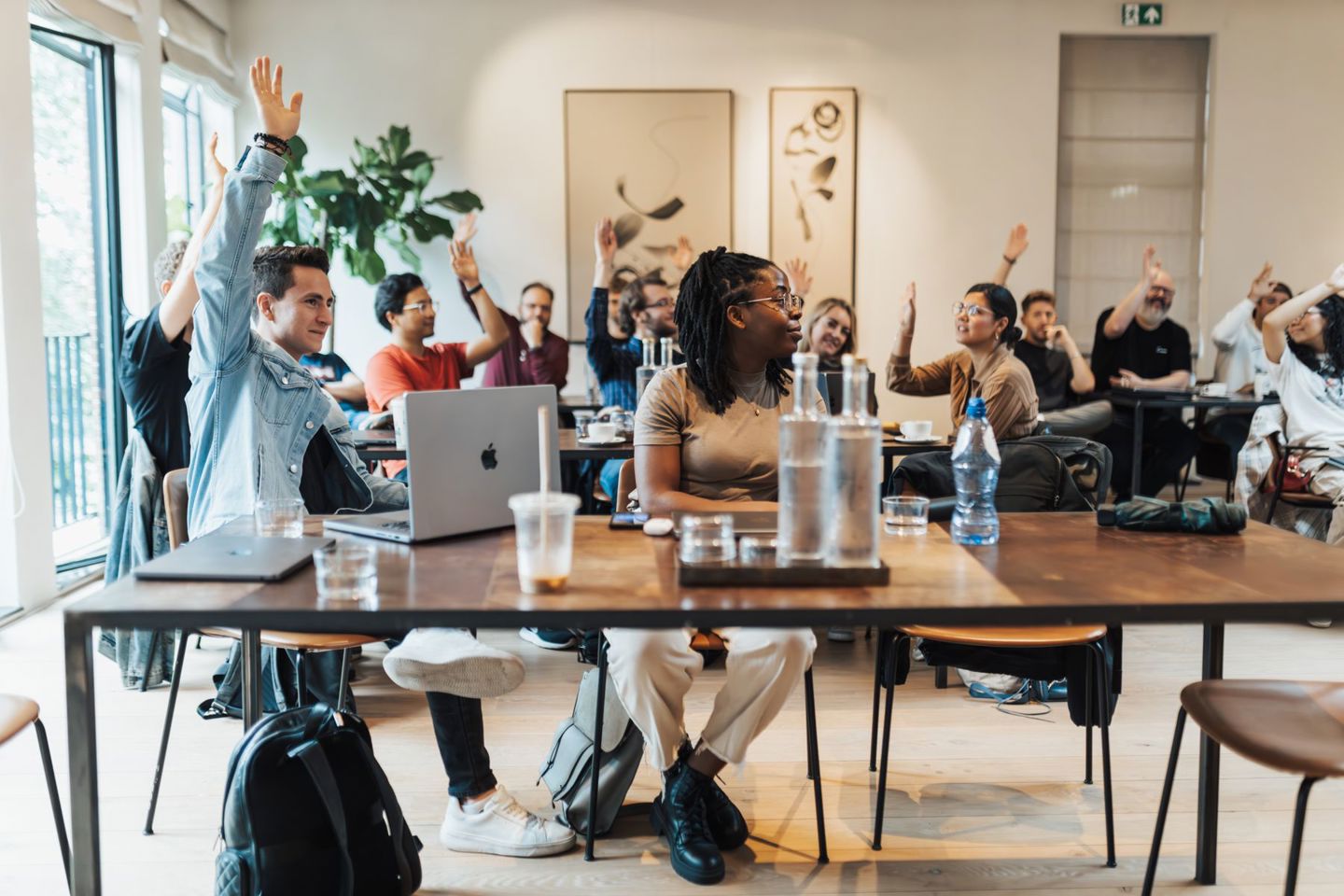 students-engaged-in-class-raising-hands
